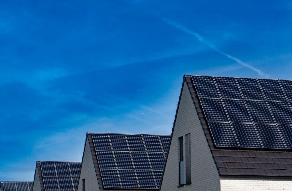 Contemporary homes featuring solar panels under a bright blue sky promoting renewable energy in South Africa after SAWEM began