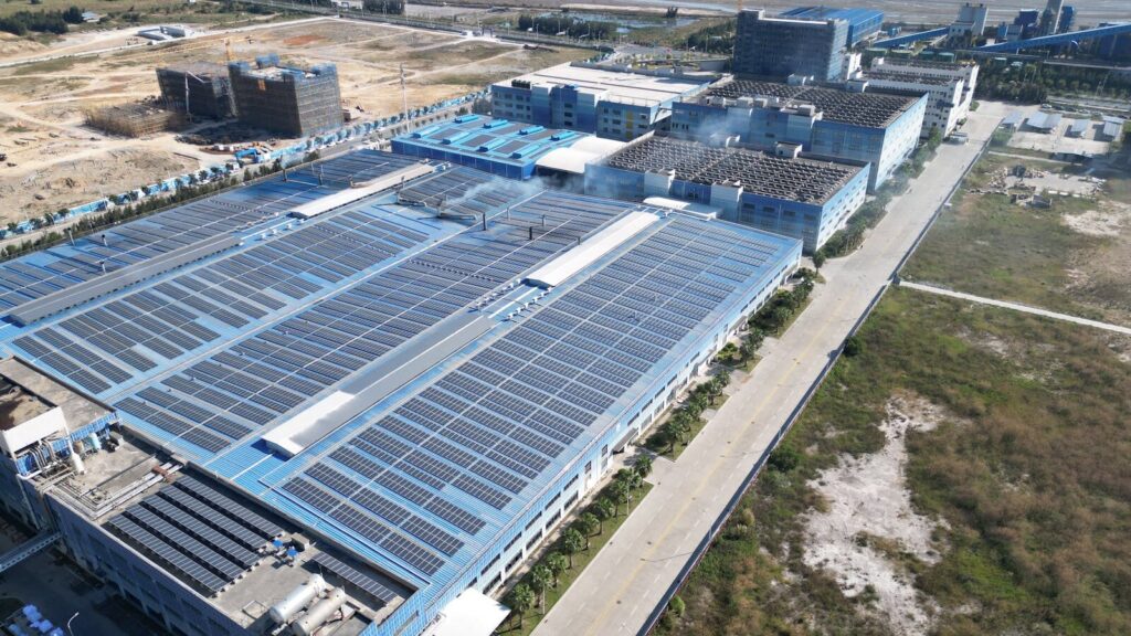 Aerial photograph showcasing large solar panels installed on an industrial building complex which will be sold to more after SAWEM